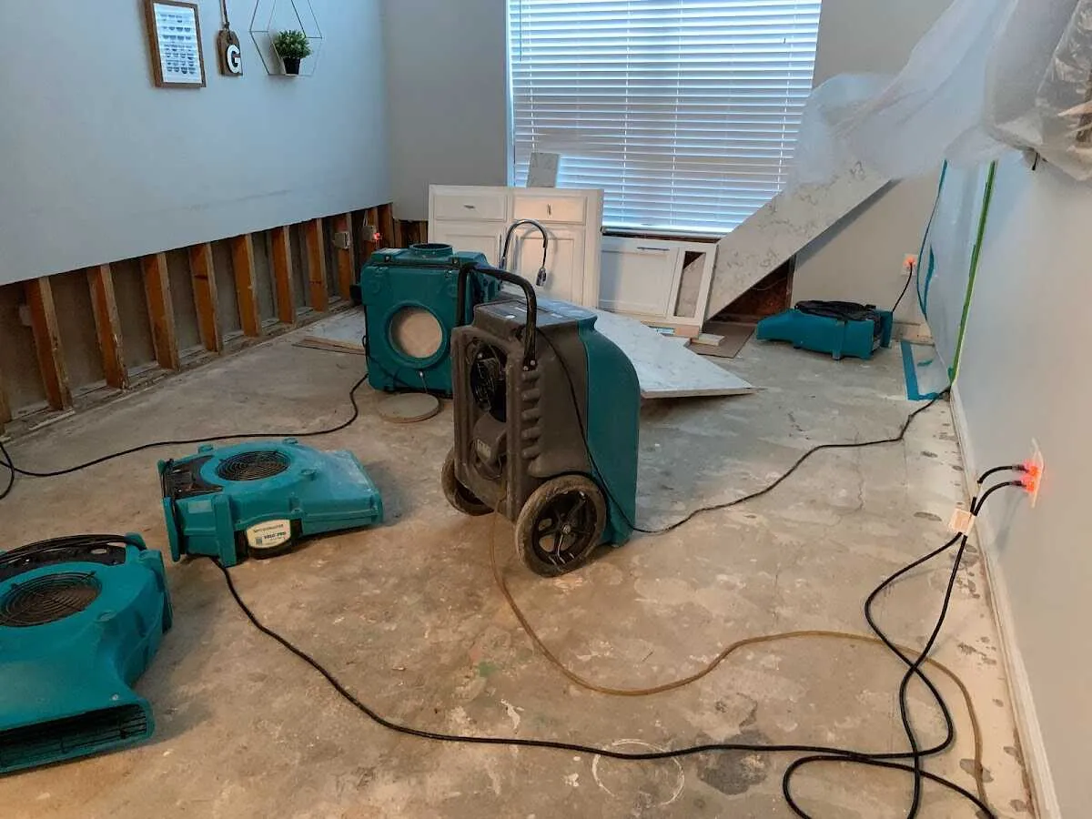 Dehumidifier in flood-cut room for Water Damage Restoration in Lower